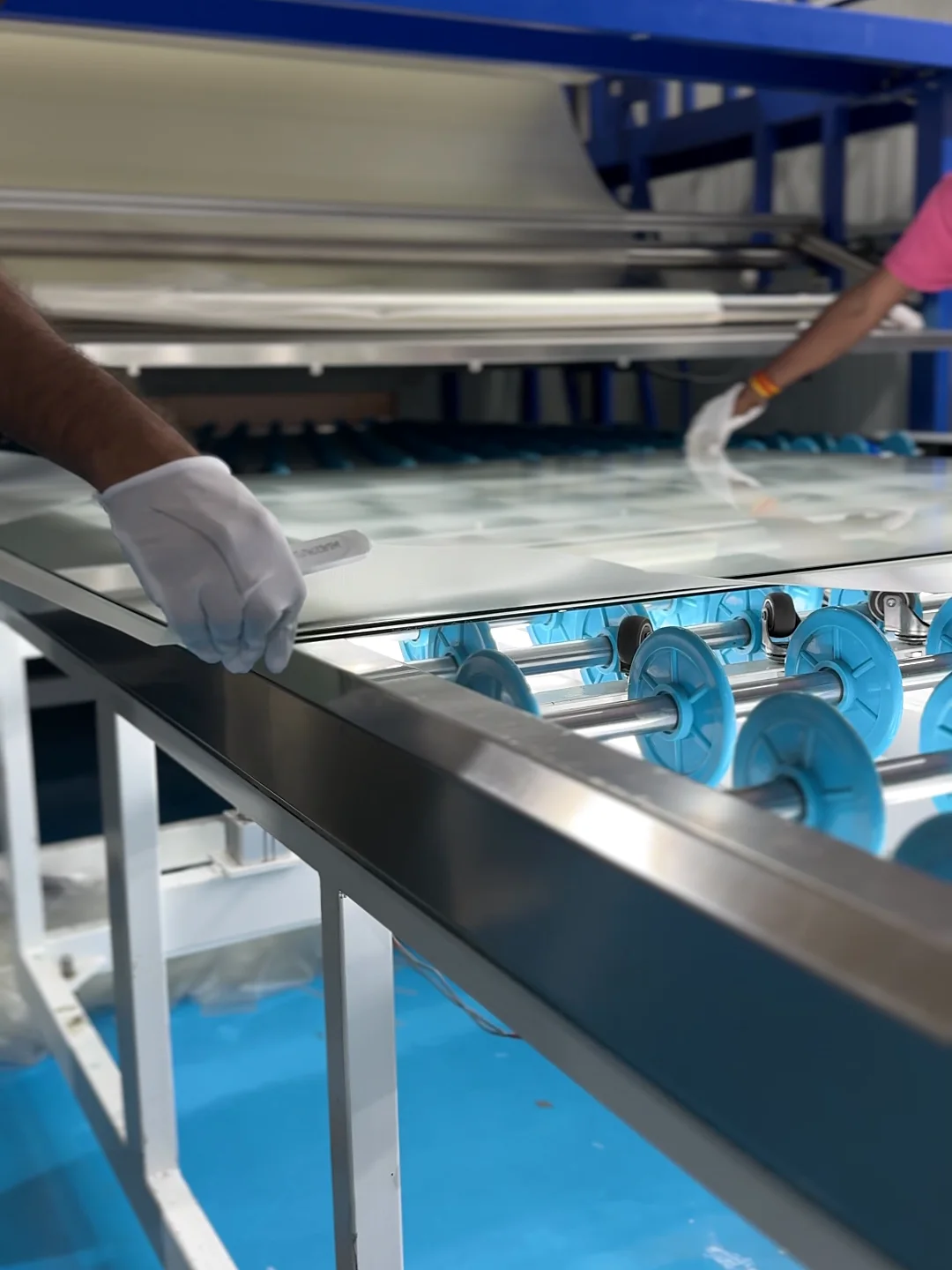 The interlayer laid over a pane by hand on ARG's jumbo lamination line